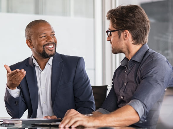 Two men having a conversation in a conference room
